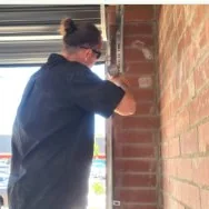 easy-glide-garage-doors-collage-1 Easy Glide Garage Doors technician repairing a garage door